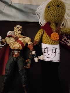 The in-progress doll, next to my Kain toy, with a paper template for the belt